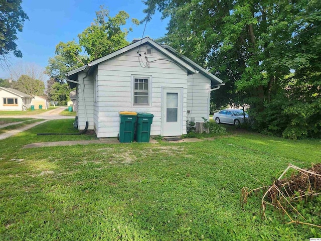 back of property featuring a yard