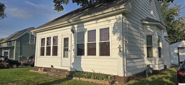 view of property exterior featuring a lawn