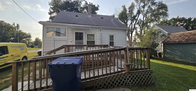 rear view of property with a yard and a deck