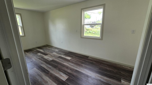 spare room featuring dark hardwood / wood-style flooring