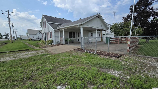 rear view of property featuring a yard