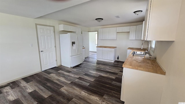 kitchen featuring wood counters, sink, white cabinets, dark hardwood / wood-style flooring, and white fridge with ice dispenser