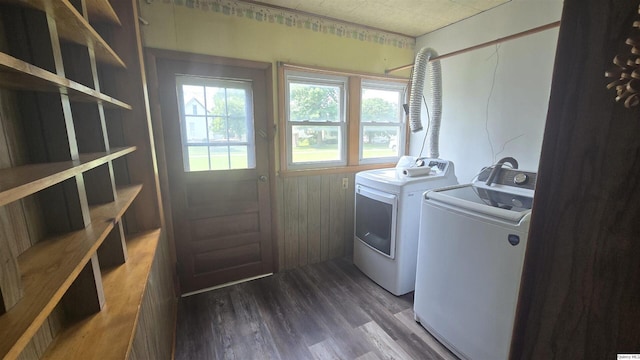 clothes washing area featuring dark wood-type flooring and washer and dryer