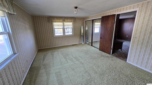 unfurnished bedroom featuring carpet flooring and a textured ceiling