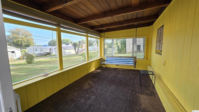 unfurnished sunroom featuring wood ceiling and beam ceiling