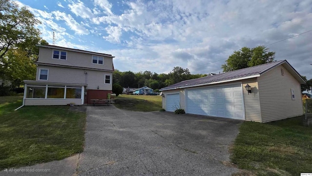 view of side of property featuring a garage, a yard, and an outbuilding