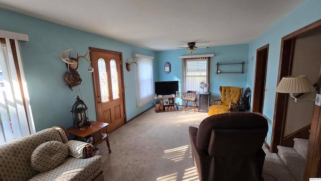 carpeted living room featuring ceiling fan