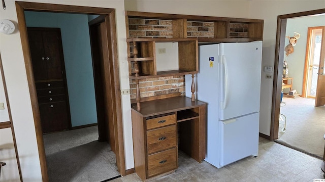 kitchen featuring white refrigerator and light colored carpet