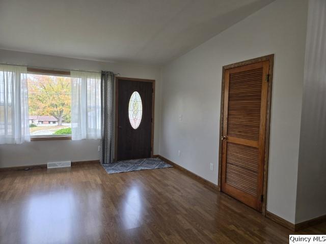 entrance foyer with dark hardwood / wood-style flooring and vaulted ceiling