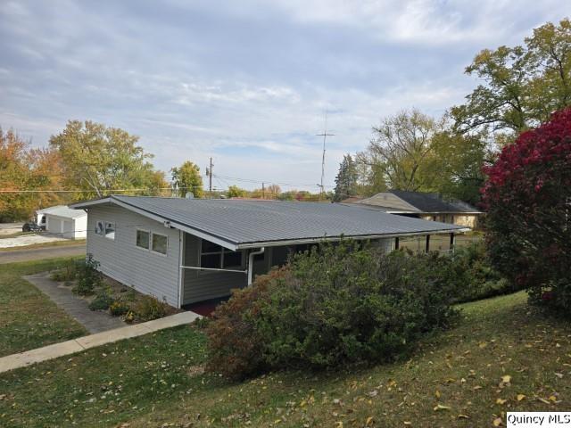 view of property exterior featuring a yard