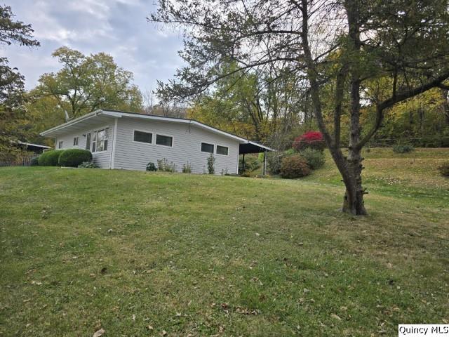 view of side of property with a yard