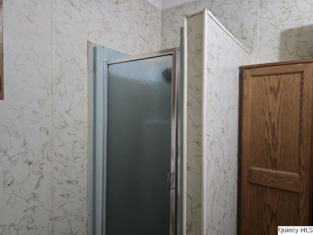 bathroom featuring a shower with shower door