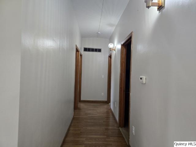 corridor with dark hardwood / wood-style floors