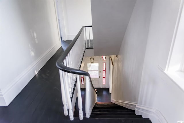 stairs featuring hardwood / wood-style flooring