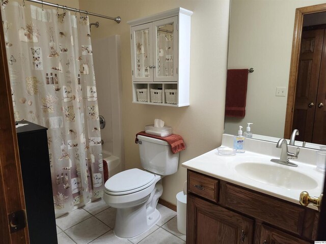 full bathroom with shower / tub combo with curtain, vanity, toilet, and tile patterned flooring