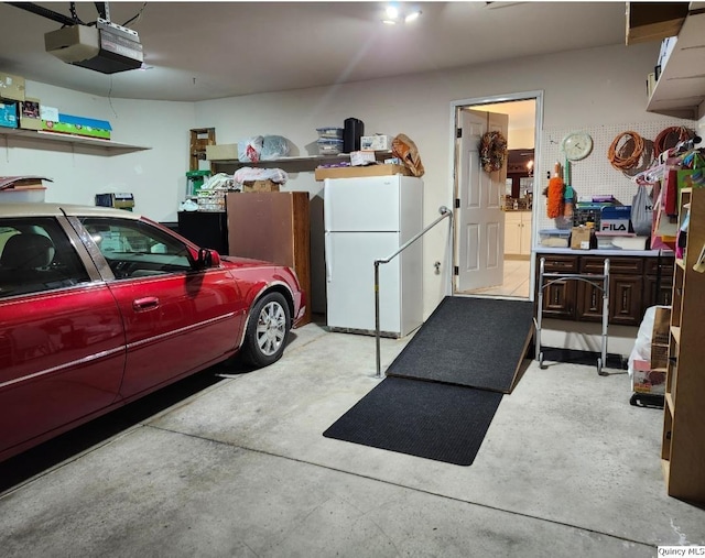 garage featuring a garage door opener and white fridge