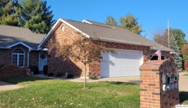 view of front of house with a garage and a front lawn