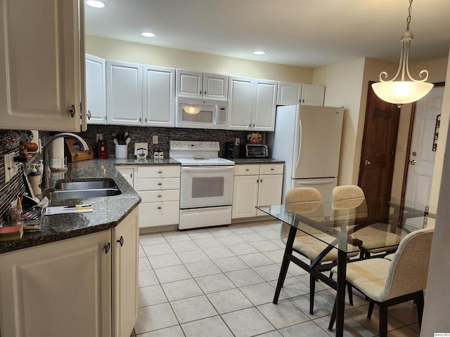 kitchen with sink, white appliances, backsplash, white cabinets, and decorative light fixtures