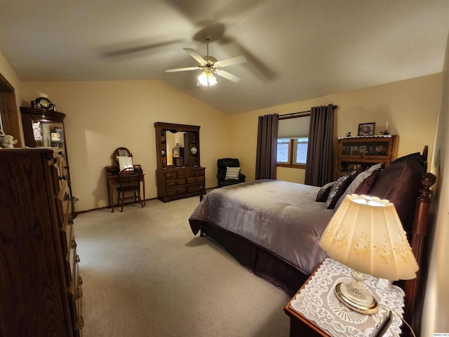 carpeted bedroom with vaulted ceiling and ceiling fan