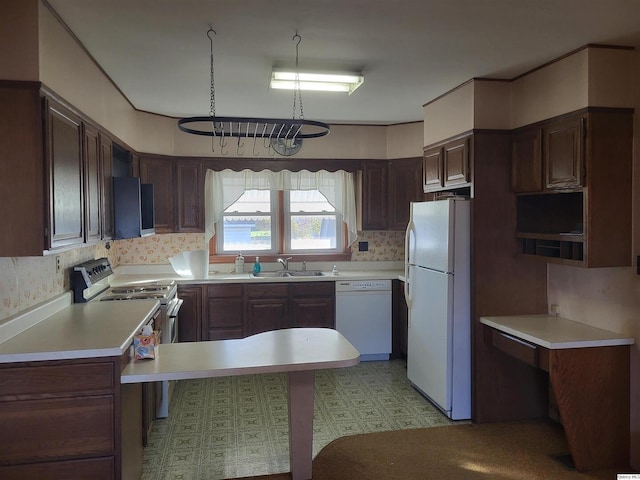 kitchen featuring sink, white appliances, and dark brown cabinets