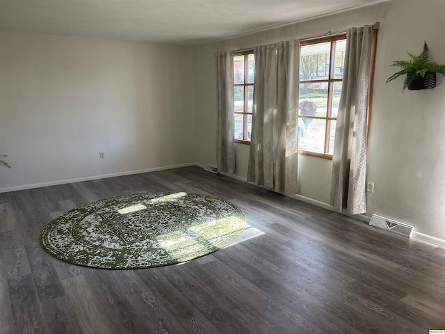 empty room featuring dark wood-type flooring