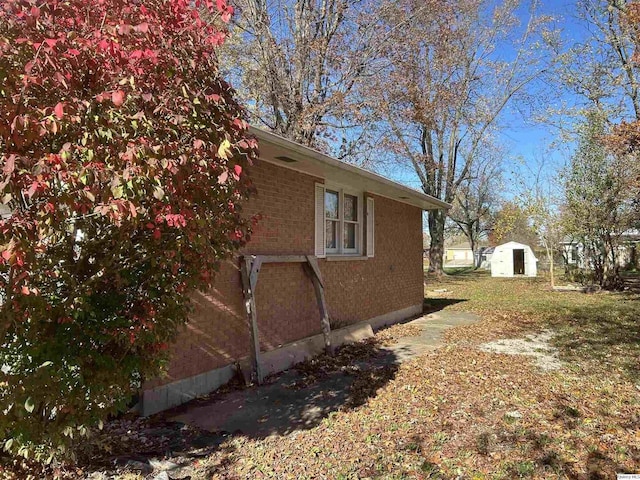 view of side of property with a storage shed