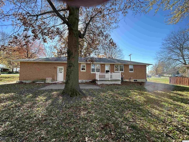 rear view of property featuring a lawn