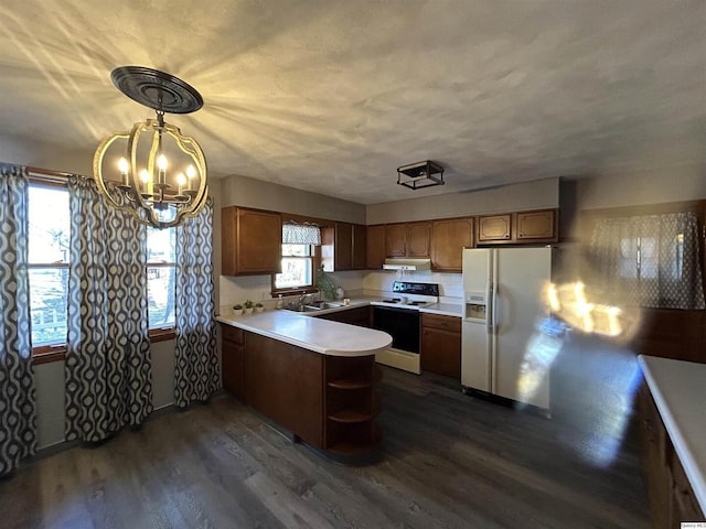 kitchen featuring electric range oven, white fridge with ice dispenser, dark hardwood / wood-style flooring, decorative light fixtures, and kitchen peninsula