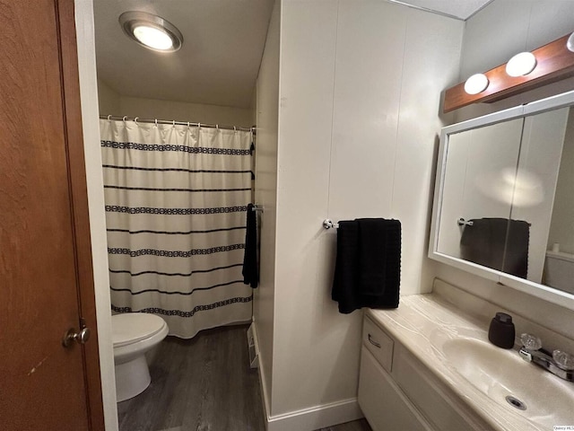 bathroom with vanity, hardwood / wood-style flooring, a shower with curtain, and toilet