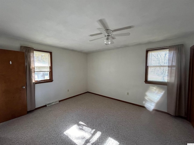 empty room featuring carpet and ceiling fan