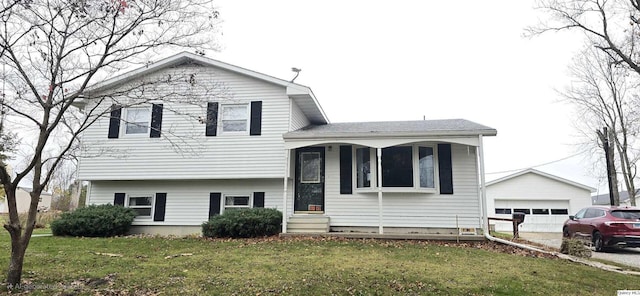 split level home with a garage, an outdoor structure, and a front lawn