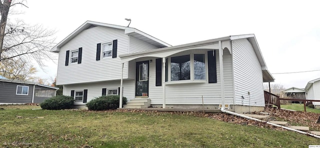 tri-level home with a front lawn