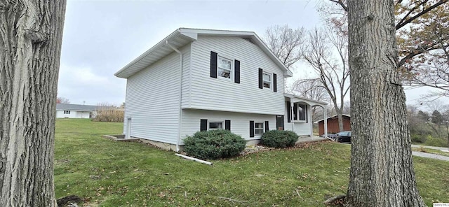 view of property exterior featuring a lawn