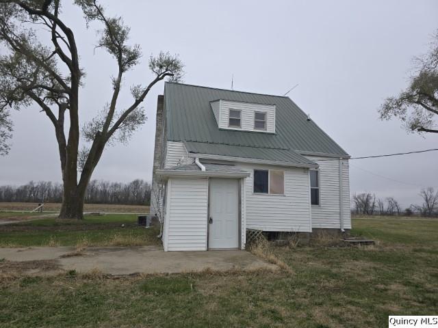 back of property featuring a yard