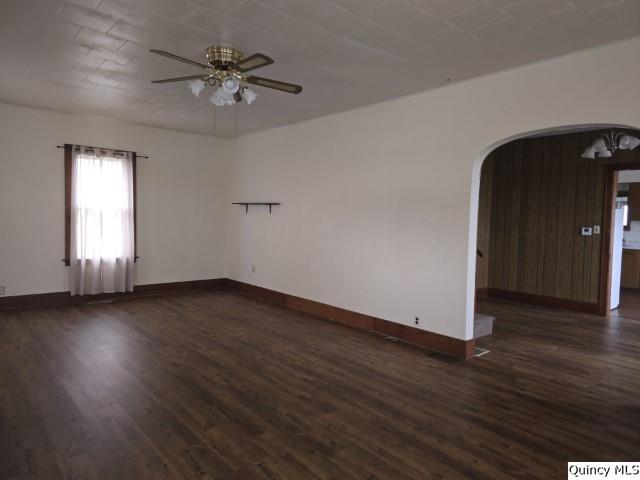 unfurnished room featuring dark wood-type flooring and ceiling fan