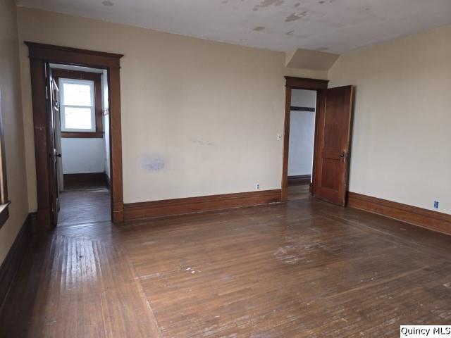 unfurnished room featuring dark hardwood / wood-style flooring