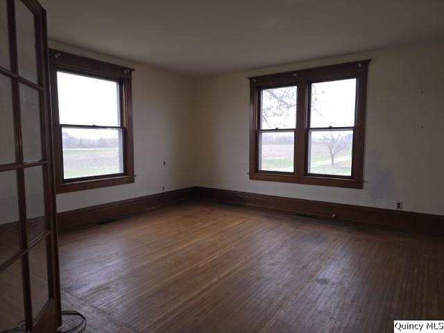 unfurnished room with dark hardwood / wood-style flooring