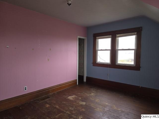 bonus room featuring lofted ceiling and dark hardwood / wood-style floors