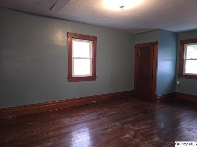 spare room featuring dark wood-type flooring