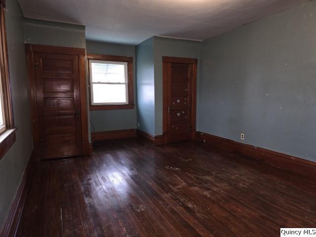 unfurnished room featuring dark hardwood / wood-style flooring