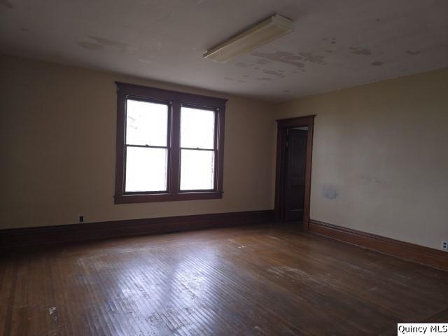 spare room featuring dark hardwood / wood-style flooring