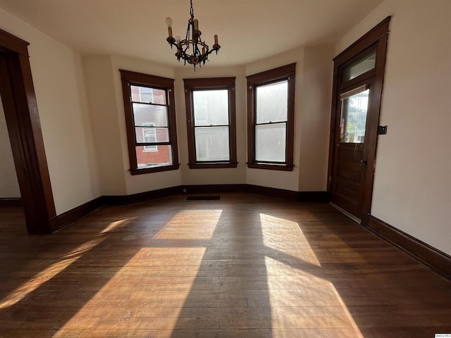 interior space featuring dark hardwood / wood-style floors and a notable chandelier