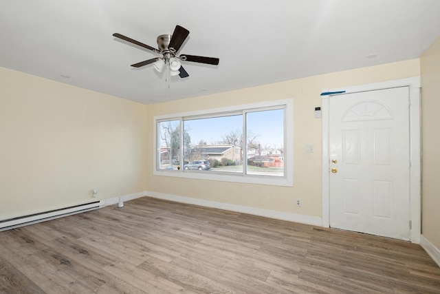 entryway with light wood-type flooring, a baseboard radiator, and ceiling fan