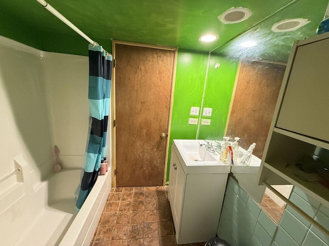 bathroom with shower / bath combo and vanity