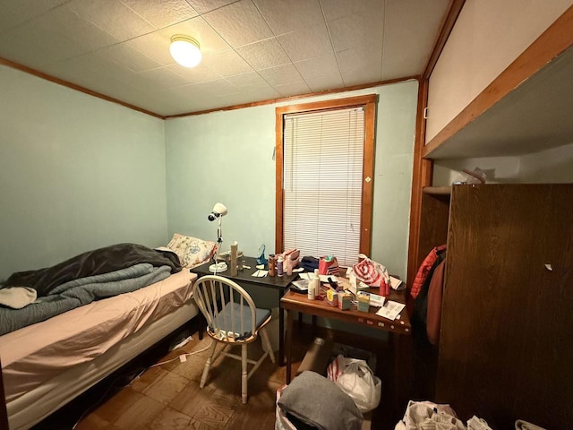 bedroom featuring crown molding and hardwood / wood-style floors