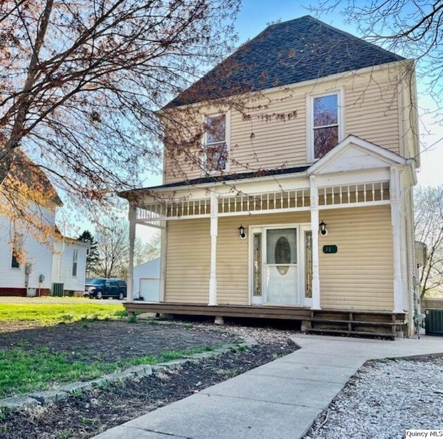 view of front of property featuring a porch, roof with shingles, and central AC