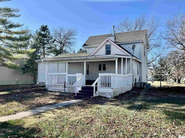 view of front facade featuring covered porch and a front lawn