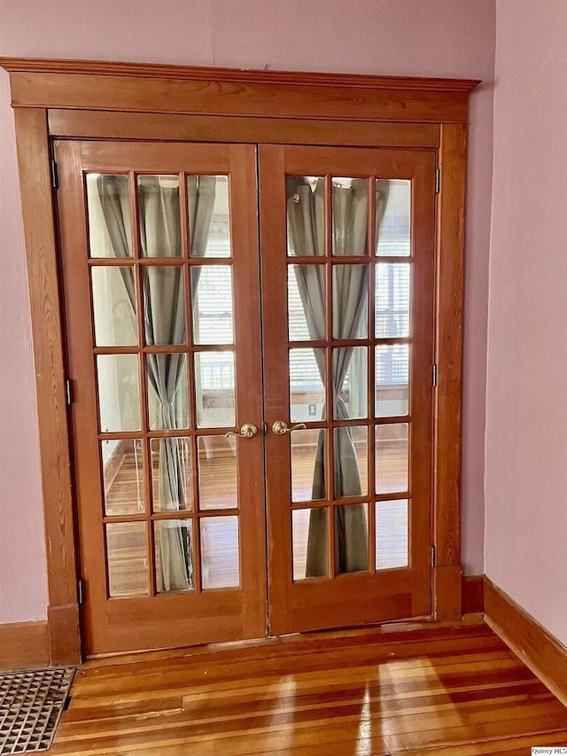 doorway to outside with wood-type flooring and french doors