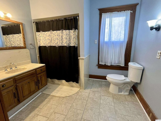 bathroom featuring vanity, toilet, and a shower with shower curtain