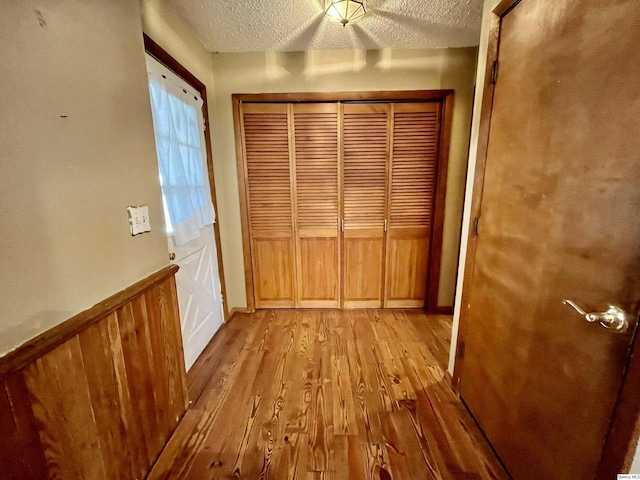 entryway featuring a textured ceiling and light hardwood / wood-style flooring